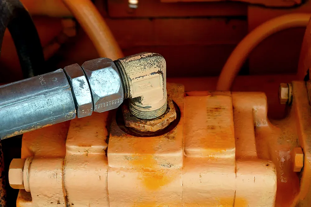 A hydraulic hose fitting on a pump body