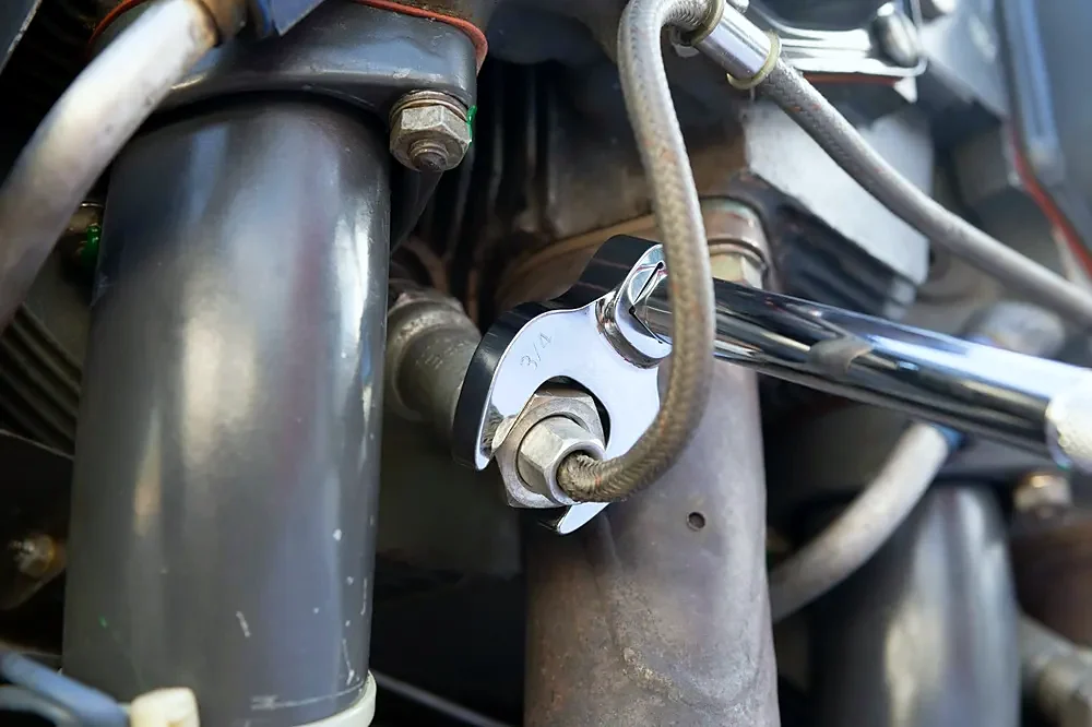 A spanner on a hydraulic hose fitting